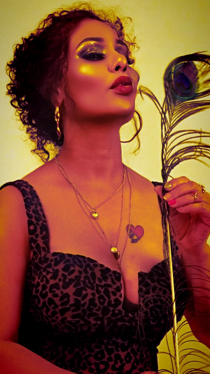 Kanak Raj - Elegant Black Dress with Peacock Feather Pose